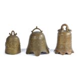 Three Chinese brass bells, to include an example with a stylised dragon, another with a flared