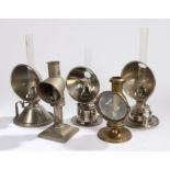 A. Barrett & Sons reflector candle lamp, three Veritas chrome reflector oil lamps, brass reflector
