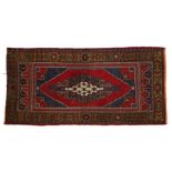 Afghanistan rug, the central medallion with blue and red borders and edged with an olive green