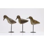 A trio of early 20th Century Shorebird decoys, the painted body with red bead eyes raised on later