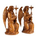 Pair of figural pricket candlesticks, each carved wood and gesso covered as angels holding pricket