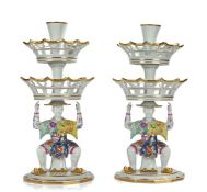 Pair of Mottahedeh porcelain epergnes, with two basket tiers above an Oriental figure in