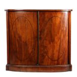 Regency mahogany bowfronted cabinet, the top above a pair of doors with oval stringing enclosing