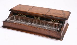 Edwardian oak ink stand fitted with three hinged lids, labelled COPYING RED BLACK, above a glass pen