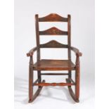 19th Century oak child's rocking chair, the slat back above a solid seat flanked by shaped arms