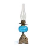 Hinks Triple No.2 oil lamp, with clear glass chimney above a blue glass reservoir and pierced