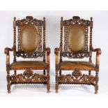 Pair of 17th Century style "Carolean" walnut armchairs, each surmounted with a pair of cherubs