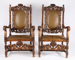 Pair of 17th Century style "Carolean" walnut armchairs, each surmounted with a pair of cherubs