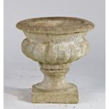 Composite garden planter, the urn planter with gadrooned body above a plinth base, 39cm wide, 38cm
