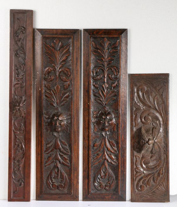 Pair of 19th Century oak panels with carved feathered faces, an 18th Century panel and a further