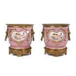 Pair of gilt mental mounted porcelain cachepots, the gilt metal bead top above a pink ground