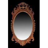 19th Century mahogany fret mirror, the oval mirror plate within a fret frame with gilt leaf drops to