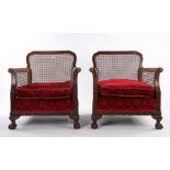 Pair of early 20th Century mahogany and caned bergere chairs, with a shaped square caned back with a