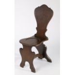 18th Century oak hall chair, the shaped back above a dished solid seat and shaped arched supports,