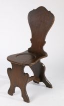 18th Century oak hall chair, the shaped back above a dished solid seat and shaped arched supports,