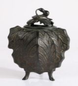 Chinese bronze incense burner and cover, the aubergine tipped lid above a arched top, and leaf