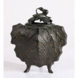 Chinese bronze incense burner and cover, the aubergine tipped lid above a arched top, and leaf