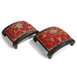 Pair of Regency footstools, the arched pad top with a foliate embroidery design above the black