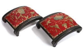 Pair of Regency footstools, the arched pad top with a foliate embroidery design above the black