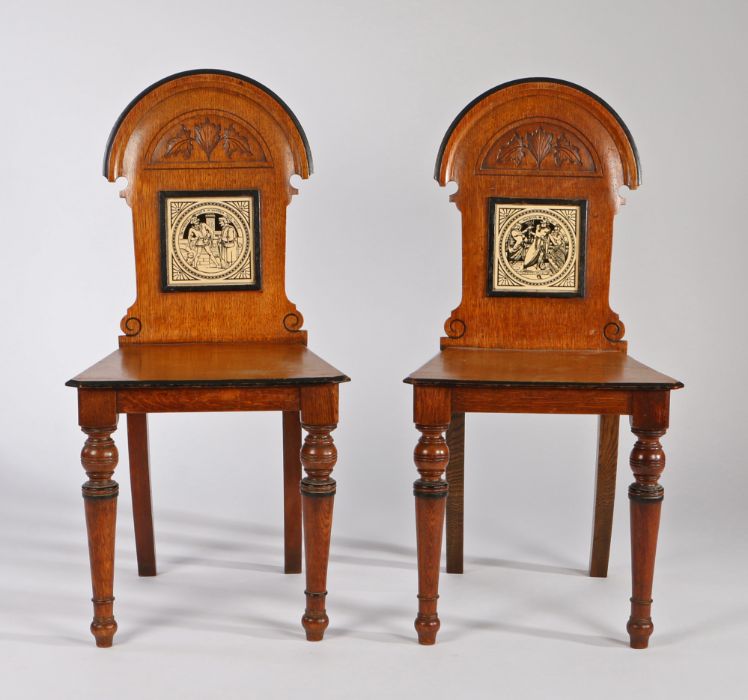 Pair of Victorian oak hall chairs, the arched backs above a tile to each by John Moyr Smith from the - Image 2 of 2