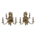 Pair of gilt metal wall lights, the five branches projecting from the leaf and the masks of