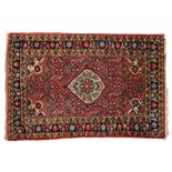 Persian Hamadan Dozar rug, centred with a flower head within diamond shaped cartouche, on red ground