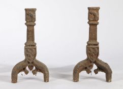 Pair of iron fire dogs, in the Gothic taste, a shield to the centre above arched legs, 44cm high, (