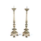 Pair of Italian pricket sticks, painted in white and green with traces of gilt, the spike top