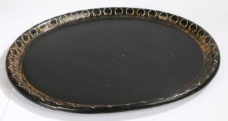 Regency papier mache tray, of large proportions, the oval black tray with gilt decoration to the