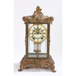 Ansonia gilt metal four glass mantel clock, circa 1900, having scrolling swags and scallop design