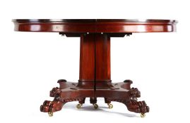 Regency style mahogany circular extending dining table, the circular top with an additional five