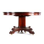 Regency style mahogany circular extending dining table, the circular top with an additional five