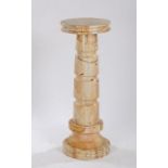 Puce veined marble column, the circular top raised on a reeded stem and circular foot, 117cm high,