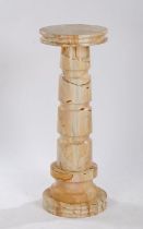 Puce veined marble column, the circular top raised on a reeded stem and circular foot, 117cm high,