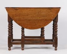 18th Century oak gateleg table, the drop flap top above a moulded frieze and turned legs above