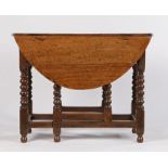 18th Century oak gateleg table, the drop flap top above a moulded frieze and turned legs above