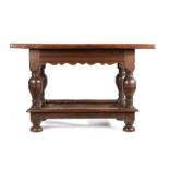 German oak table, the rectangular top above wide bulbous legs united by stretchers and bun feet,