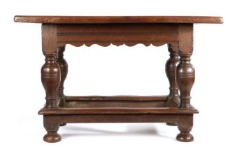 German oak table, the rectangular top above wide bulbous legs united by stretchers and bun feet,