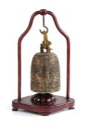 Chinese bronze bell and stand, the bell of archaistic form and dragon handle housed within the