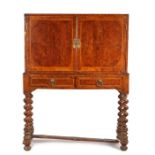 William and Mary style mahogany and burr walnut cabinet on stand, the rectangular top with feather