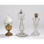 Brass oil lamp with clear glass chimney, white glass shade above a brass reservoir and foot, 23.