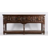 Charles II style oak dresser base, the rectangular top above a pair of geometric drawers above