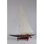 A Model of the J Class Yacht Endeavour, in blue and red, raised on stand, 107cm long