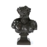 Bust of Bacchus, the patinated copper overlaid bust of a grinning Bacchus above the plinth base,