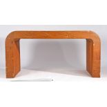 20th Century oak veneered modernist desk, the rectangular top with arched ends and block supports,