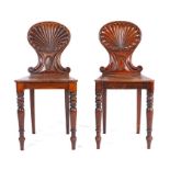 Pair of George III mahogany carved shell back hall chairs, possibly by Gillows of Lancaster, the