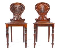 Pair of George III mahogany carved shell back hall chairs, possibly by Gillows of Lancaster, the