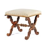 Victorian walnut foot stool, the pad seat with an inverted concave edge above a scrolling X frame