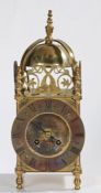 17th Century style brass lantern Clock, the final top above a bell and dolphin fret mounts, the