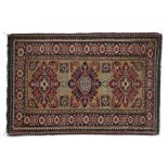 Caucasian Zaronim rug, with a row of three diamond shaped motifs within a blue border, 90cm long x